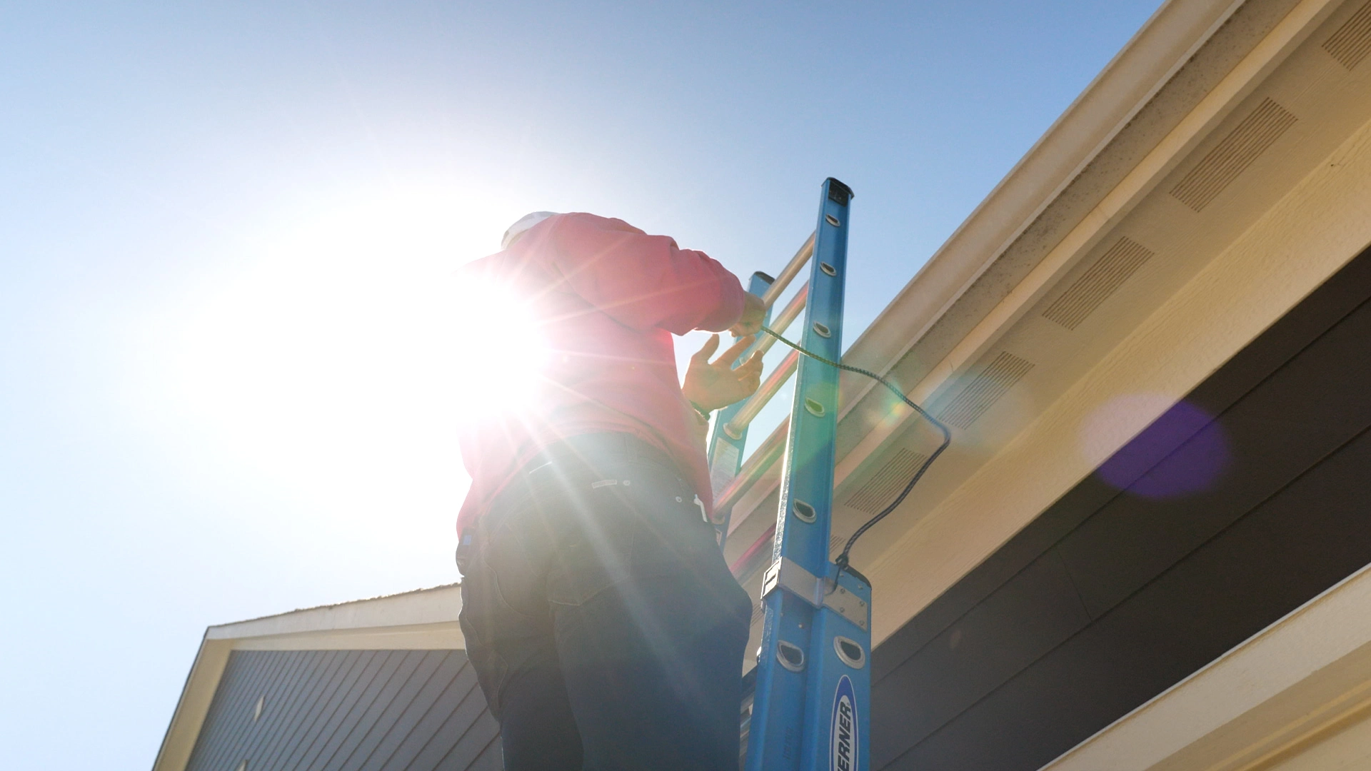 open box contractor inspecting roof on ladder