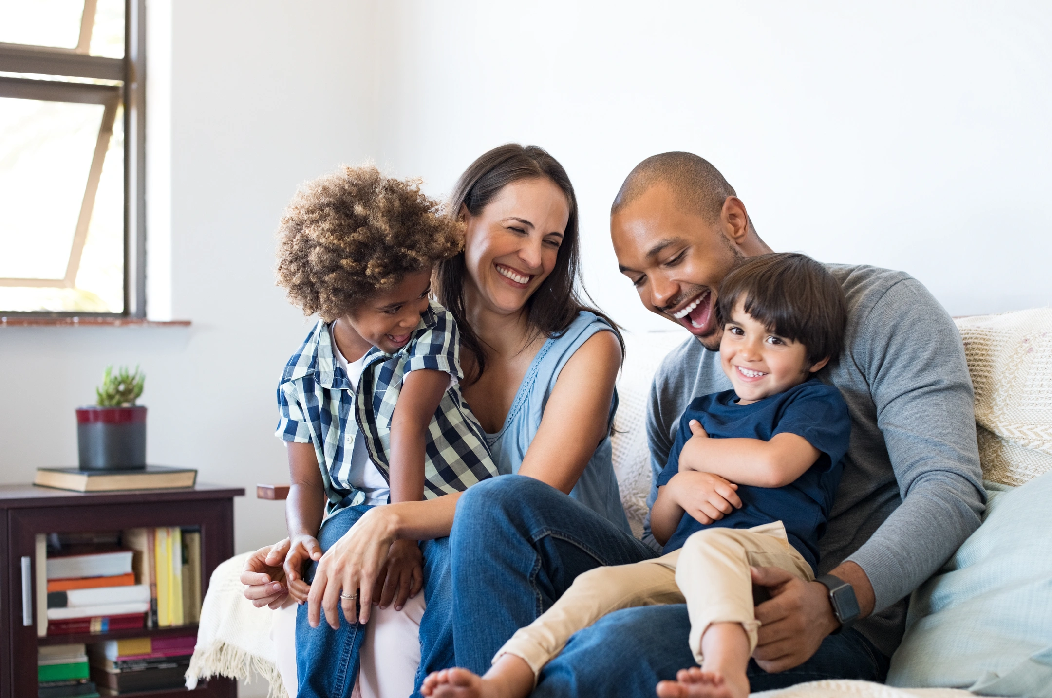 happy couple playing with children after financing home repairs