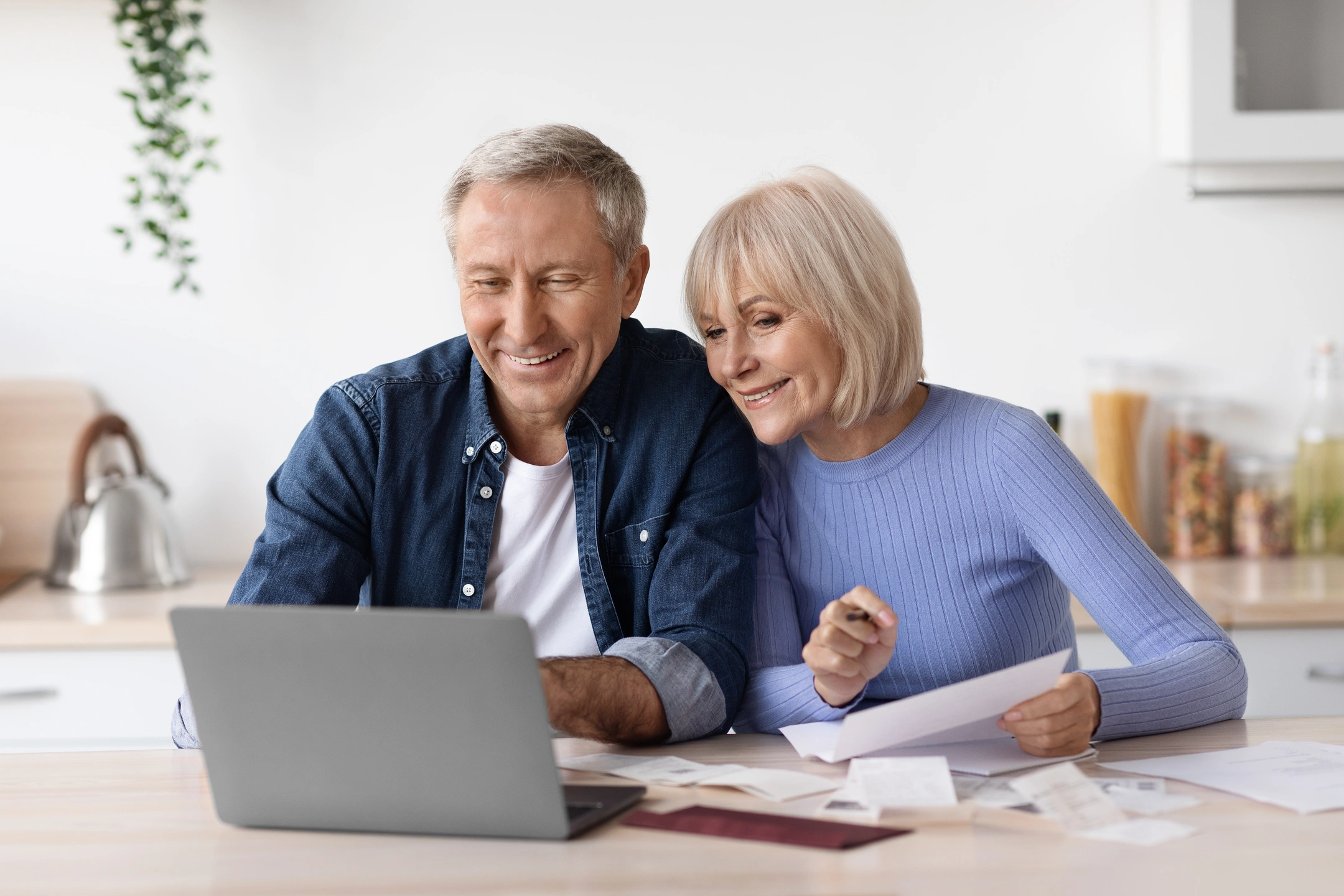 older couple going over finances on computer before roof replacement