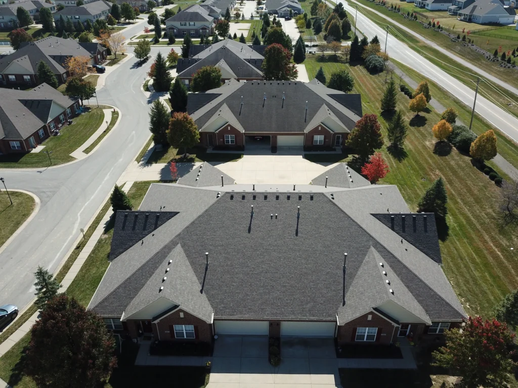 arial view of residential roof repair with dark shingles