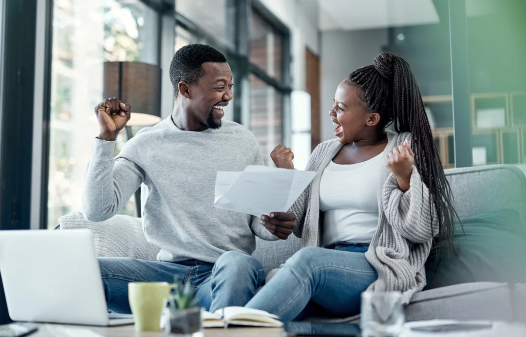 young black couple celebrating at home