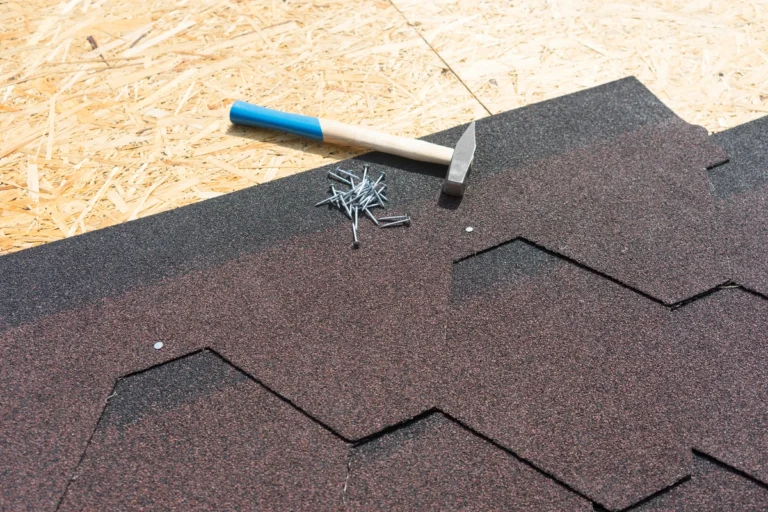 process of installing architectural shingles with a hammer