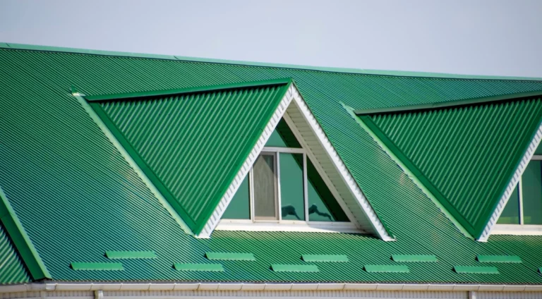 green metal roof on a building with plastic windows