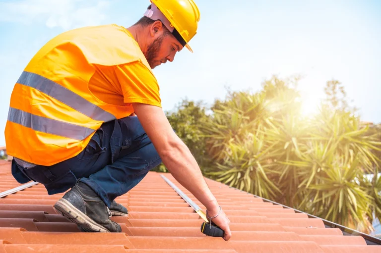 worker taking measurements of the roof