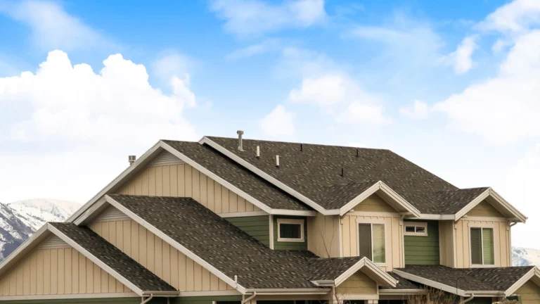 house roof with asphalt shingles against blue sky