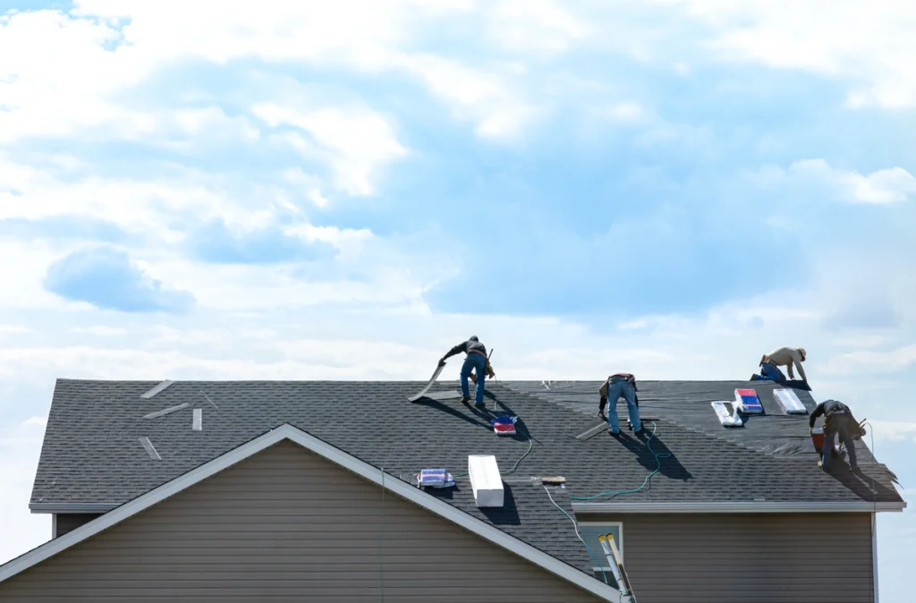 Roofing contractors working to replace full roofing system