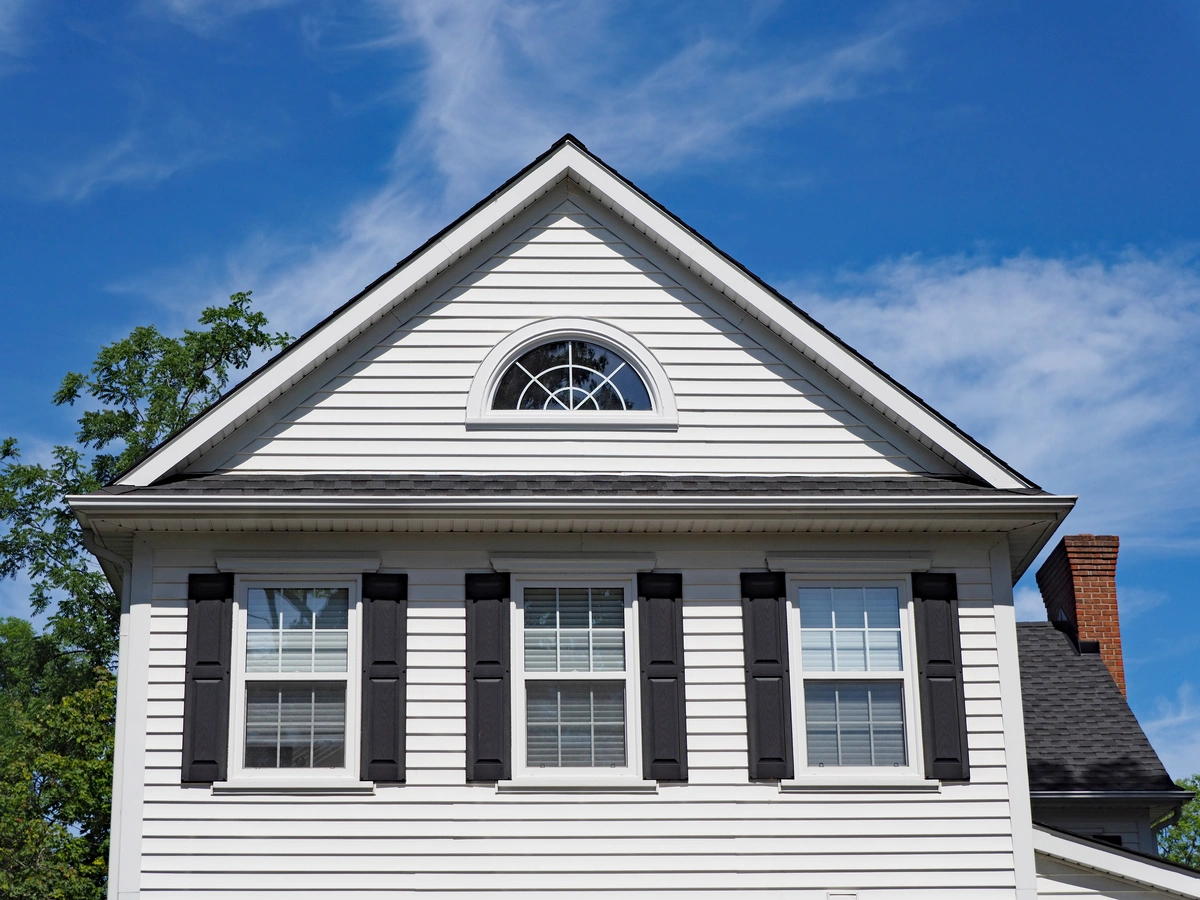gable roof house with white vinyl siding