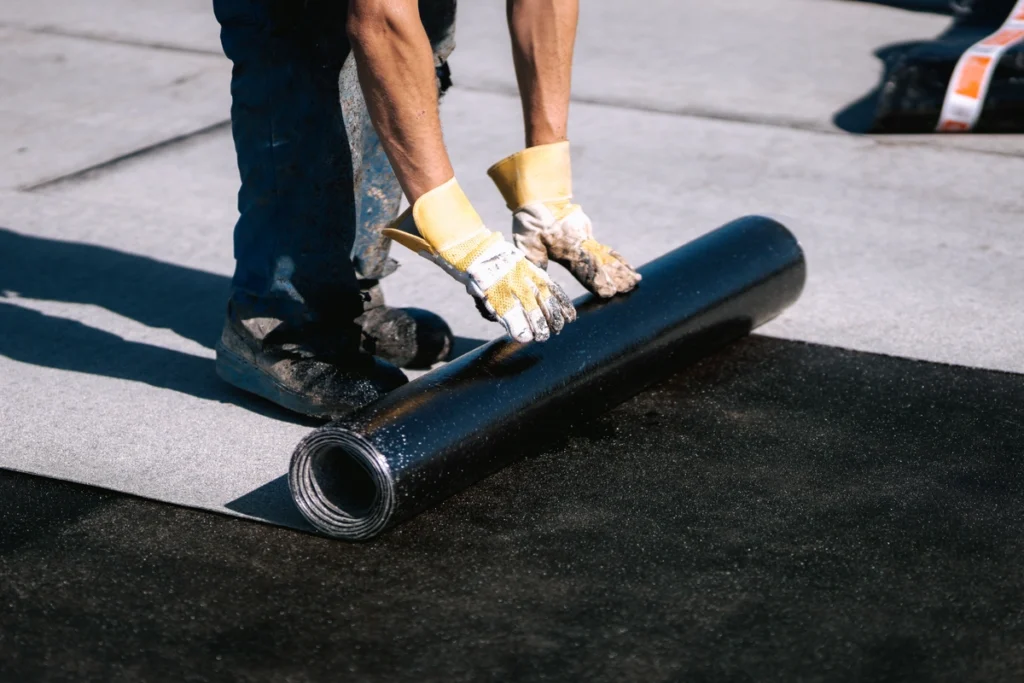 unrolling flat roofing material